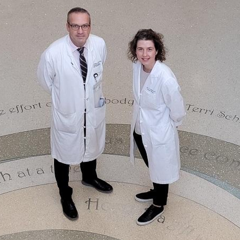 Dr. Brent Hanks and Dr. April Salama standing in Duke Cancer Center lobby.